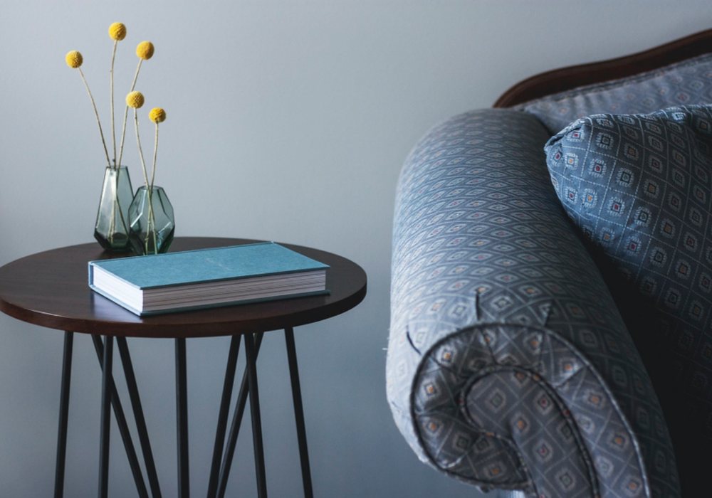 A simple living room corner with a side table and chair